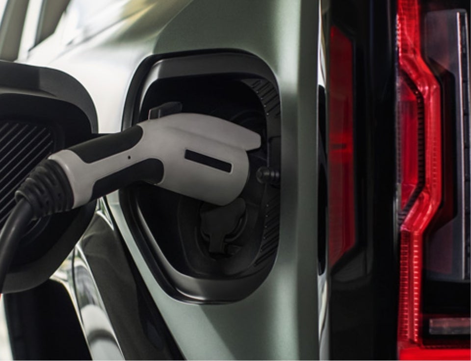 Close up of charging port with charger plugged in on a GMC Hummer EV SUV - Wallingford GMC in WALLINGFORD CT